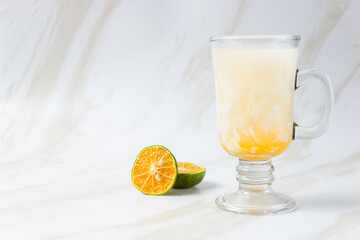 Es Kelapa Jeruk, a typical Indonesian drink made from fresh oranges squeezed with grated young coconut. with copy space. perfect for recipe, article, catalogue, or any commercial purposes.