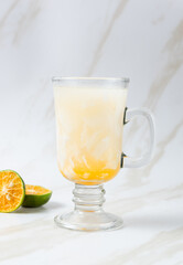 Es Kelapa Jeruk, a typical Indonesian drink made from fresh oranges squeezed with grated young coconut. with copy space. perfect for recipe, article, catalogue, or any commercial purposes.