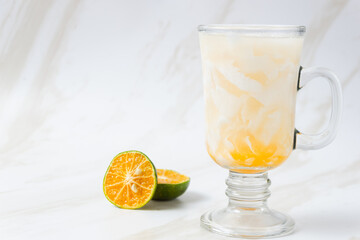 Es Kelapa Jeruk, a typical Indonesian drink made from fresh oranges squeezed with grated young coconut. with copy space. perfect for recipe, article, catalogue, or any commercial purposes.
