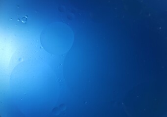 Una toma de cerca de una fondo abstracto de color azul con burbujas de diferentes tamaños