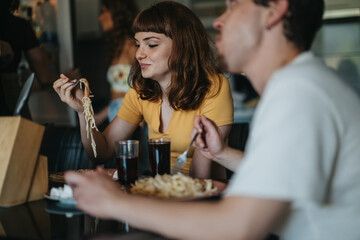 A group of friends delighting in a pasta meal at a cozy restaurant, enjoying their time together in a warm, friendly setting.