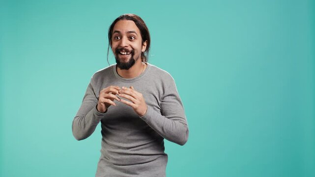 Disappointed man admonishing friend over debacle, isolated over blue studio background. Upset person in disagreement with mate, pointing finger and lecturing him, camera B