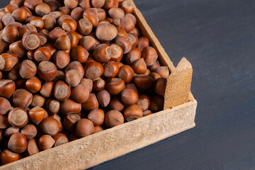 Pile of hazelnuts in a wooden crate