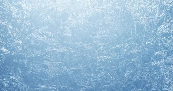 Frost covered window with lights shimmering and glittering over ice crystals. Sparkling frozen winter background.