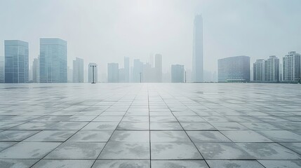 Fototapeta premium A wide shot of an empty urban plaza with a hazy cityscape in the background.
