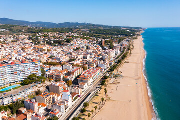 Fototapeta premium Aerial photo of Spanish municipality Canet de Mar with view of beach and residential buildings.