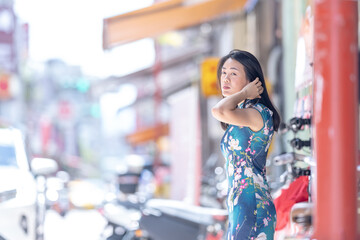 A Taiwanese woman in her 30s wearing traditional Chinese clothing is standing on Dihua Street in Taipei City, Taiwan, in September.