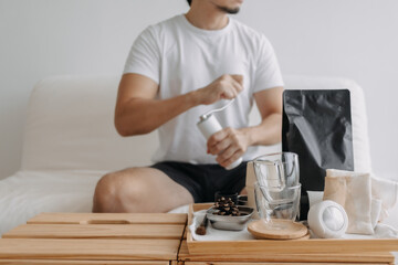 Step by step of Asian man making espresso with hand press tools.