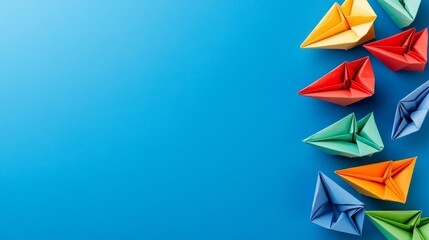 Leadership Concept with Paper Boats. Set of colorful origami ships on blue background.