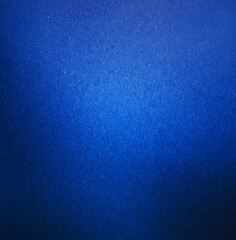 Abstract close-up of a blue textured background featuring a smooth gradient effect and subtle surface details.
