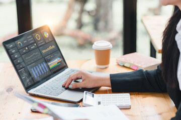 Businesswoman or an accountant team are analyzing data charts, graphs, and a dashboard on a laptop...
