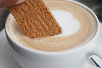 Dunking a Delicious Biscuit into a Warm and Inviting Cup of Freshly Brewed Coffee