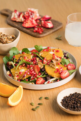 Vegan salad with citrus fruits, lettuce leaves and pomegranate. Christmas salad. 