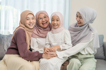 three different female generations meeting at home,sitting on couch in living room,hugging with love, smile,affection,enjoy holiday time together