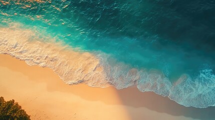 A calm beach with turquoise waters and soft white sand, glowing under the warm colors of a vibrant sunrise, creating a serene coastal view