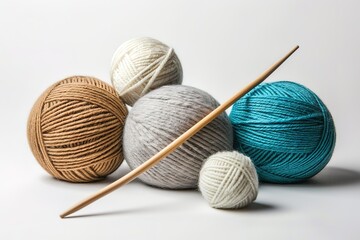 A wooden knitting needle sits in front of a pile of yarn balls