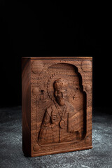 The Christian icon is made of solid wood by the milling method. Church equipment. Greeting card for...