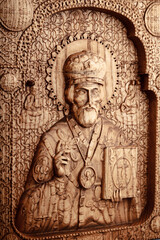 Fototapeta premium The Christian icon is made of solid wood by the milling method. Church equipment. Greeting card for the Ascension of Jesus Christ. Background for Christmas card.