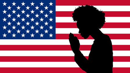 Silhouette of an African American Woman Praying on an American Flag