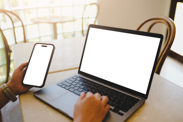 A blank screen for hand typing text,using laptop and mobile phone contact business searching information in workplace on desk at office.