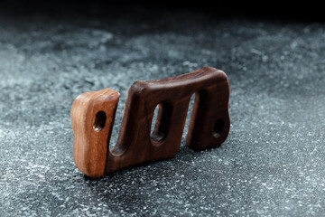 Wooden stand for smartphone. Miniature pocket tripod for hiking. A device for fixing a smartphone while traveling. Device for bloggers.
