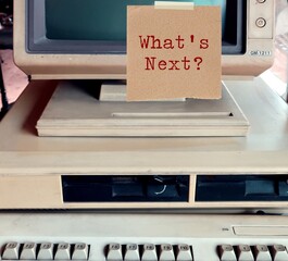 Old school vintage computer desktop with sticky note written WHAT'S  NEXT?, concept of technology...