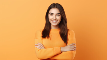 Obraz premium Portrait of a cute smiling girl woman l looking happy and thankful, receiving a gift and admire it, staring at camera pleased with hands pressed to chest, orange background.