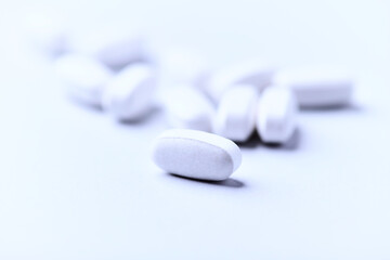 Amino acids tablets. Nutrition for bodybuilding. Fitness supplements on bright background. Soft focus. Copy space.	