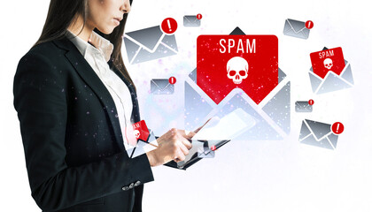 Businesswoman using a tablet with spam email icons on white