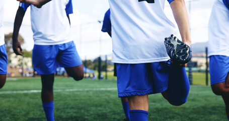 People, legs and stretching with fitness on soccer field for sports game, exercise and warm up challenge. Team, men and prepare for football competition, workout performance and tournament training © AzeemudDeen/peopleimages.com