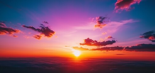 Naklejka premium Breathtaking sunset over the horizon, showcasing vibrant colors of purple, orange, and pink against a serene sky.