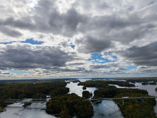 Aerial view of small islands dotting the calm waters of the Thousand Islands region, showcasing the scenic landscape and natural beauty of the Canadian side.