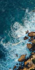 Obraz premium Aerial View of Turquoise Ocean Waves Crashing on Rocky Shoreline