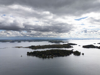 Aerial view of the serene 1000 Islands on the Canada side, showcasing lush, forested islands scattered across calm waters, ideal for nature enthusiasts and explorers.