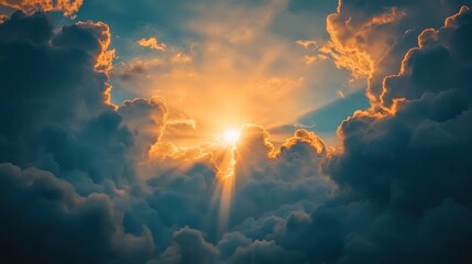 Fototapeta premium A dramatic sunset breaking through clouds, illuminating the sky with warm colors.