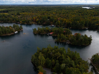 Obraz premium Tranquil aerial view of the 1000 Islands region, showcasing scattered islands on serene waters under a vast sky, capturing natural beauty and peacefulness.