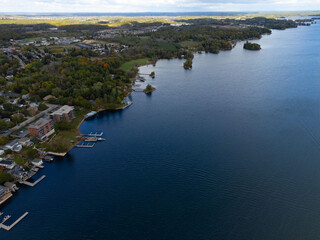 Tranquil aerial view of the 1000 Islands region, showcasing scattered islands on serene waters under a vast sky, capturing natural beauty and peacefulness.