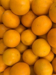 Fresh orange fruits as background top view.
