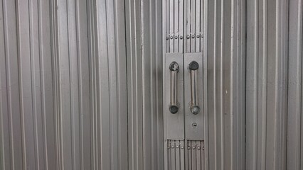 Obraz premium Metal Rolling Door with Industrial Themes Chrome Handles
