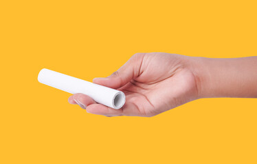 Closeup Photo Of A Male Hand Holding A New White PVC Plastic Pipe Isolated On Yellow Background