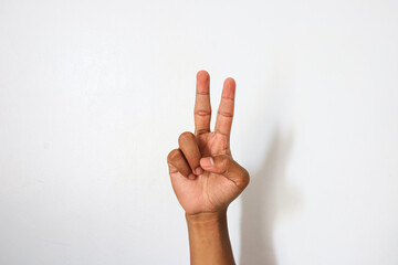 Naklejka premium Indonesian hand with 2 open finger gesture