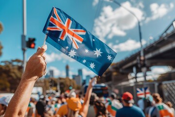 Australian flag celebration at outdoor event with crowd and sunny sky.