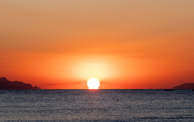 Sunrise over the sea in the early morning. The moment of separation of the sun from the water.