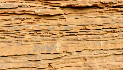 Natural abstract stratified stoner rock formation exhibits multicolored layered textures with rugged patterns and earthy tones ideal for banners or backgrounds.