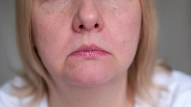 offended angry woman sticking out tongue close-up mouth drink lower lip purse lips roll up upper lip displeased expression unpleasant emotions negative