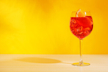 A cocktail arranged on a table against a light yellow background