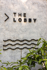 Hotel lobby sign with black text. Hotel sign on marble wall that says Lobby. Hotel lobby of a...