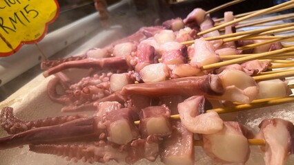 Fresh Squids and octopus for sale in the seafood market.Fresh seafood for sale in a butcher shop.Fish and meat on the stall. selling sea food in traditional market. Traditional butcher stall.