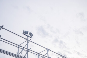 Metal Structure with Lights. A close-up shot of a metal structure with lights against a cloudy sky.