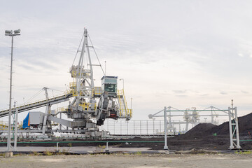 Industrial Crane at Coal Loading Facility. A large industrial crane used for loading coal at a facility.